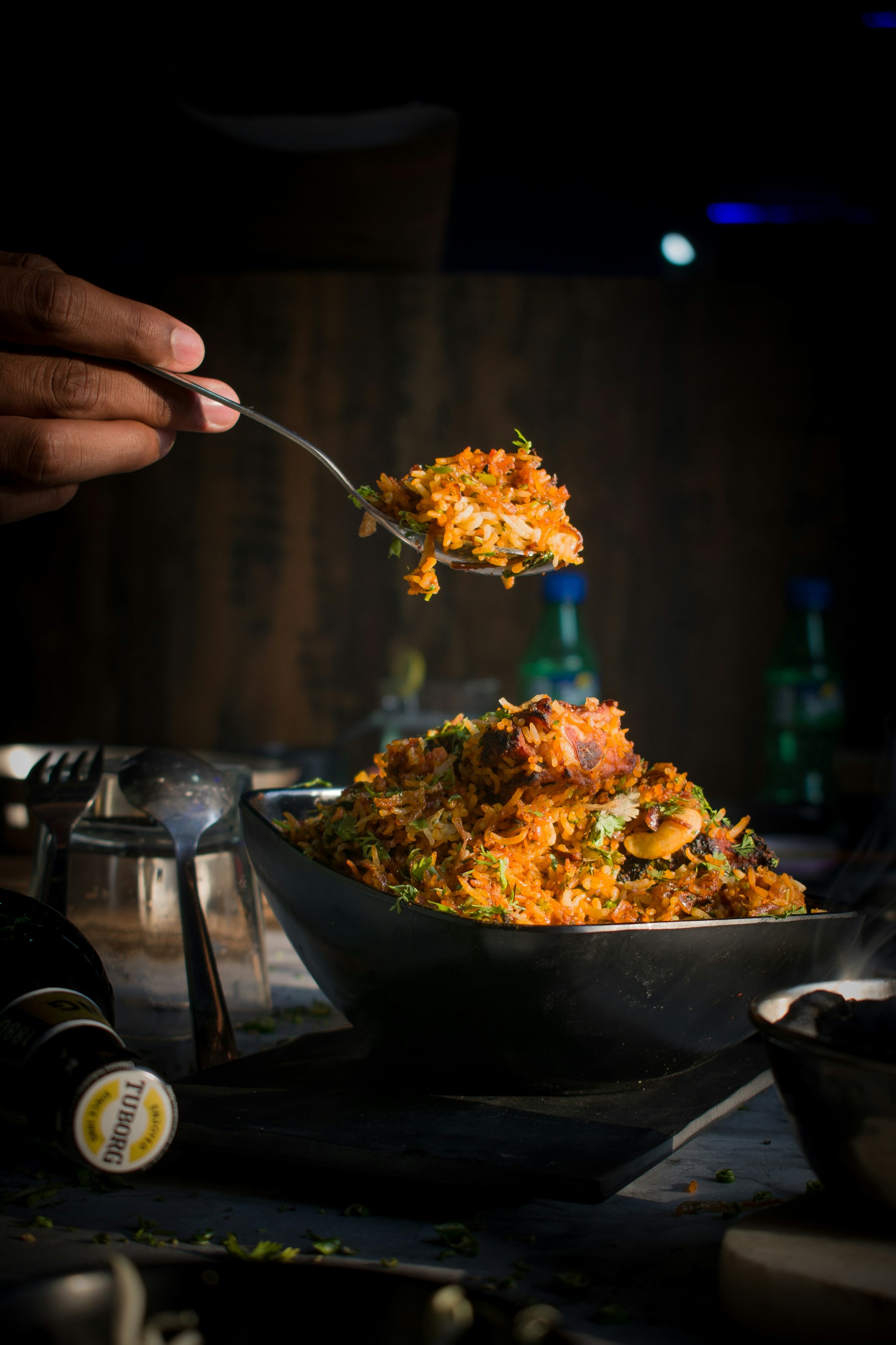 Hyderabadi shaadi biryani being served from a large degh